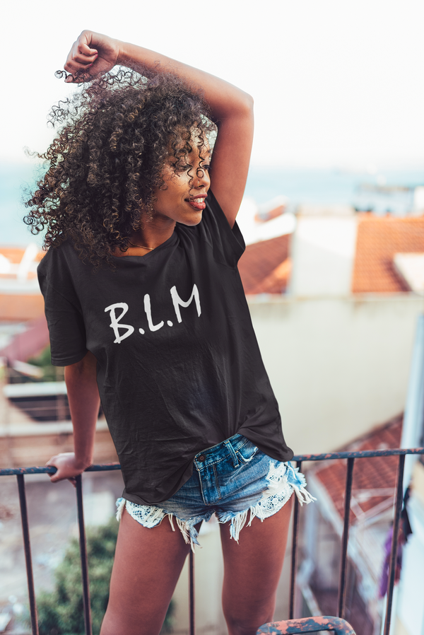 mockup of a curly haired woman wearing an oversized t shirt on a balcony